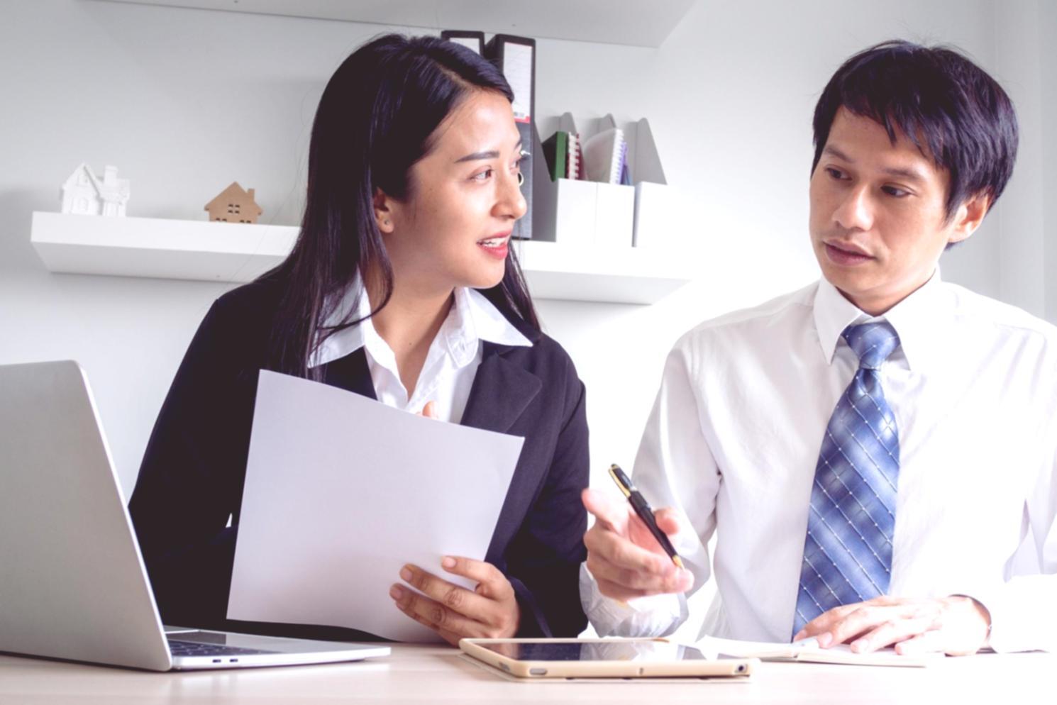 Modern financial analysis workspace with professionals collaborating